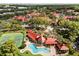 Community aerial view showcases a pool, tennis courts, and lush surroundings among residential buildings with red roofs at 236 Afton Sq # 109, Altamonte Springs, FL 32714