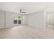 Large, neutrally painted bedroom featuring wood-look tile flooring and a sliding glass door leading to the outside at 236 Afton Sq # 109, Altamonte Springs, FL 32714