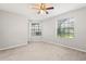 A neutrally decorated bedroom, with wood-look tile flooring and two windows at 236 Afton Sq # 109, Altamonte Springs, FL 32714
