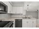 Bright kitchen features granite countertops, stainless steel appliances, and white cabinets at 236 Afton Sq # 109, Altamonte Springs, FL 32714