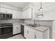 Bright kitchen features granite countertops, stainless steel appliances, and white cabinets at 236 Afton Sq # 109, Altamonte Springs, FL 32714