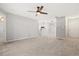 Open-concept living room with wood-look tile flooring, neutral walls, and a ceiling fan at 236 Afton Sq # 109, Altamonte Springs, FL 32714