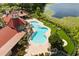 Bird's eye view highlights the community swimming pool surrounded by lounge chairs, tropical landscaping, and well-kept grounds near the lake at 236 Afton Sq # 109, Altamonte Springs, FL 32714