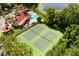 Aerial shot showcases well-maintained tennis courts near the clubhouse and pool, surrounded by lush greenery and the nearby lake at 236 Afton Sq # 109, Altamonte Springs, FL 32714