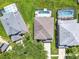 Aerial view features a home's roof and screened-in pool area, nestled between neighboring properties at 2705 Grand Harbour Ct, Kissimmee, FL 34747