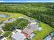 Aerial view features a backyard pool and landscaping, set within a suburban community and green space at 2705 Grand Harbour Ct, Kissimmee, FL 34747