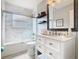 A well-lit bathroom featuring modern fixtures and a shower-tub combination at 2705 Grand Harbour Ct, Kissimmee, FL 34747