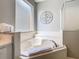 Bathroom boasts a soaking tub, white tile, and a bright frosted window over the tub at 2705 Grand Harbour Ct, Kissimmee, FL 34747