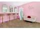 A pink themed bedroom with multiple mirrors, bar stools, sofa and 'Hello Gorgeous' neon sign at 2705 Grand Harbour Ct, Kissimmee, FL 34747