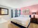 A bedroom with a blue bed frame, pink wall and decorative accents at 2705 Grand Harbour Ct, Kissimmee, FL 34747