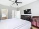 Bedroom with a large bed, dark wood furniture, ceiling fan, and en-suite bathroom at 2705 Grand Harbour Ct, Kissimmee, FL 34747