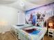 A themed bedroom featuring Frozen decor, twin beds and a chandelier at 2705 Grand Harbour Ct, Kissimmee, FL 34747