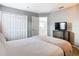 Bedroom with a TV, closet, and an open doorway to a loft area at 2705 Grand Harbour Ct, Kissimmee, FL 34747