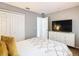 Bedroom features a TV, closet, and neutral walls at 2705 Grand Harbour Ct, Kissimmee, FL 34747