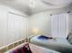 Charming bedroom featuring two twin beds with bright Frozen-themed linens, a ceiling swag, and double closets at 2705 Grand Harbour Ct, Kissimmee, FL 34747