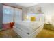 A bedroom with a white bedframe, colorful art and sheer curtains at 2705 Grand Harbour Ct, Kissimmee, FL 34747