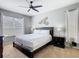 Comfortable bedroom with carpet flooring, ceiling fan, and natural light from two windows at 2705 Grand Harbour Ct, Kissimmee, FL 34747