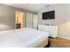 Calm bedroom features a white comforter, a TV and dresser, and dual closets for ample storage at 2705 Grand Harbour Ct, Kissimmee, FL 34747