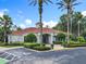 Beautiful community clubhouse featuring lush landscaping and ample parking at 2705 Grand Harbour Ct, Kissimmee, FL 34747