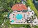 Aerial view of a large community pool area with lounge chairs and lush landscaping at 2705 Grand Harbour Ct, Kissimmee, FL 34747