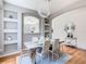 Elegant dining room showcasing modern chandelier, white furniture, and decorative shelving at 2705 Grand Harbour Ct, Kissimmee, FL 34747