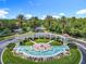 Scenic entrance to Emerald Island, featuring a water fountain, lush landscaping, and palm trees at 2705 Grand Harbour Ct, Kissimmee, FL 34747
