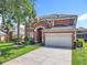 Charming two-story home with a well-manicured lawn and a two-car garage at 2705 Grand Harbour Ct, Kissimmee, FL 34747