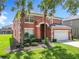 Beautiful two-story house with mature trees and a well-kept lawn at 2705 Grand Harbour Ct, Kissimmee, FL 34747
