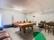 Spacious game room with a pool table, gaming chairs, a leather couch, and entertainment space at 2705 Grand Harbour Ct, Kissimmee, FL 34747