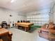 Finished garage space with a pool table and couches for entertaining at 2705 Grand Harbour Ct, Kissimmee, FL 34747
