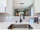Close-up of kitchen sink, backsplash, and view into the elegant dining room at 2705 Grand Harbour Ct, Kissimmee, FL 34747