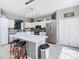 Open concept kitchen featuring stainless steel appliances, white cabinets, pendant lighting, and a center island at 2705 Grand Harbour Ct, Kissimmee, FL 34747
