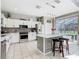 Modern kitchen with white cabinets, stainless steel appliances, and a view of the screened-in pool at 2705 Grand Harbour Ct, Kissimmee, FL 34747
