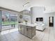 Spacious kitchen featuring an island, and connecting to a cozy living area with pool views at 2705 Grand Harbour Ct, Kissimmee, FL 34747