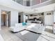 Open floor plan features a bright living room with a view of the modern kitchen at 2705 Grand Harbour Ct, Kissimmee, FL 34747