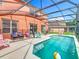 Enjoy this covered swimming pool with outdoor seating, perfect for relaxation and entertaining at 2705 Grand Harbour Ct, Kissimmee, FL 34747