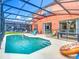 Relaxing screened-in pool area with colorful lounge chairs and pool toys at 2705 Grand Harbour Ct, Kissimmee, FL 34747