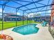 Screened-in pool area with clear blue water and a well-maintained backyard at 2705 Grand Harbour Ct, Kissimmee, FL 34747