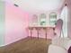 Pink room features a vanity with three mirrors and Hollywood-style lighting at 2705 Grand Harbour Ct, Kissimmee, FL 34747