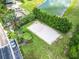 Aerial view of a sandy volleyball court with trees and landscaping nearby at 2705 Grand Harbour Ct, Kissimmee, FL 34747