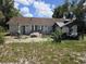 View of the home's backyard featuring a patio, chairs and outdoor dining area at 2798 Beckwith St, Deltona, FL 32738