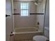 Cozy bathroom showcasing white subway tiles, a bathtub with shower, and classic fixtures for a clean, timeless look at 2798 Beckwith St, Deltona, FL 32738