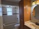 Bathroom featuring a tub and shower combo with tiled walls and a vanity with sink and storage cabinet at 2798 Beckwith St, Deltona, FL 32738