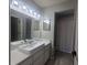 Bathroom with a modern vessel sink, a large mirror, and updated lighting fixtures at 2798 Beckwith St, Deltona, FL 32738