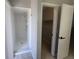 Bright bathroom featuring a walk-in shower with tiled walls, and access to a closet, promoting comfort and practicality at 2798 Beckwith St, Deltona, FL 32738