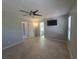 Bedroom featuring a ceiling fan, a television and an ensuite bathroom at 2798 Beckwith St, Deltona, FL 32738