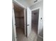 A glimpse into an airy bedroom with neutral tones, featuring an open closet door, offering a blend of space and functionality at 2798 Beckwith St, Deltona, FL 32738