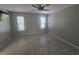 Bedroom with neutral walls, tiled floors, and natural light from the two windows at 2798 Beckwith St, Deltona, FL 32738
