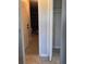 Hallway with tiled floors leading to the garage featuring an access door and a closet at 2798 Beckwith St, Deltona, FL 32738