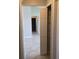 Hallway featuring tile flooring, a storage closet and neutral colored walls at 2798 Beckwith St, Deltona, FL 32738